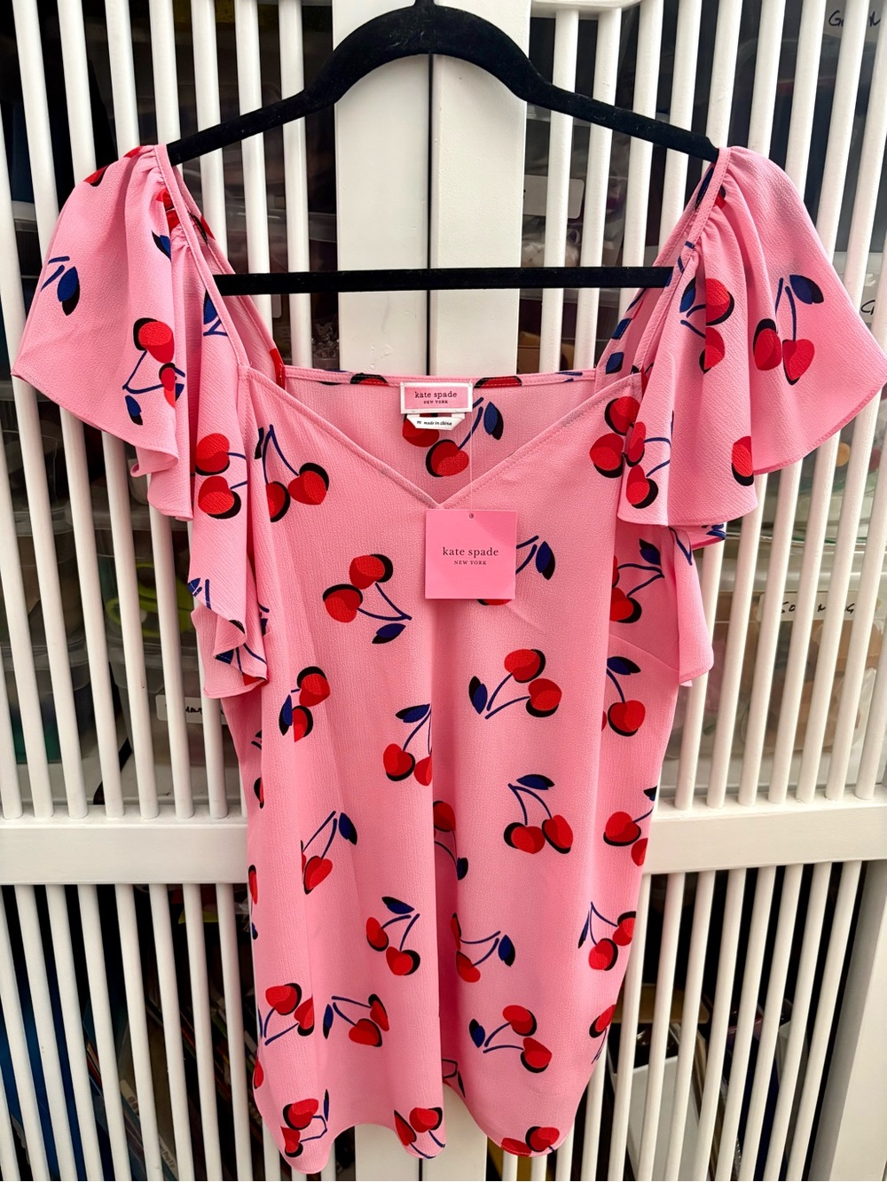 Kate Spade pink cherry print blouse with red and blue accents